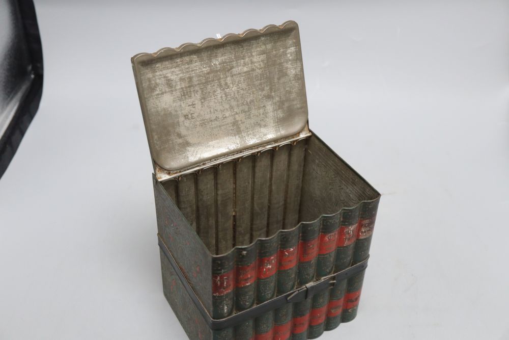 A biscuit tin in the form of eight leather bound Old Curiosity Shop books, (Huntley and Palmer), height 16cm